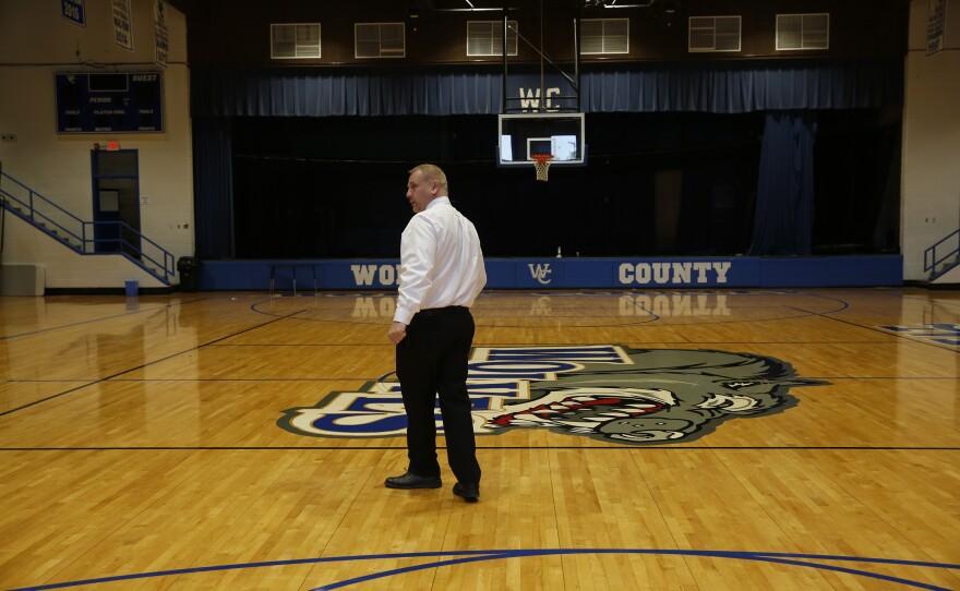 Bell, who was a basketball star when he was a student at Wolfe County High School, gives a tour of the gym.