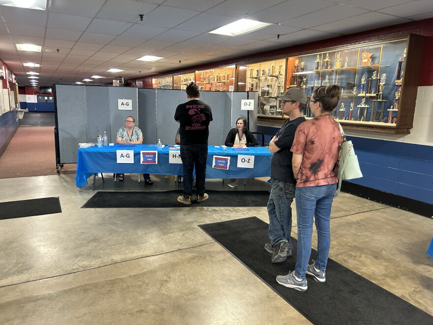 Voters wait in line to check in on Primary Election Day, Aug. 11, 2026, at the Chisholm Sports Arena complex. In addition to statewide races, Chisholm voters were narrowing the field among mayoral candidates.