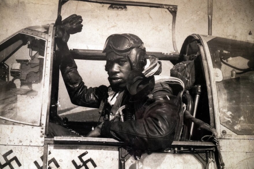 A photograph of Tuskegee Airman Lt. Col. Bertram W. Wilson in the cockpit of his plane can be seen in the New England Air Museum exhibit.