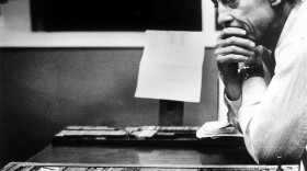 Ben Bradlee, then-executive editor of <em>The Washington Post,</em> looks at the front page of the newspaper, headlined "Nixon Resigns," in the composing room on Aug. 8, 1974.