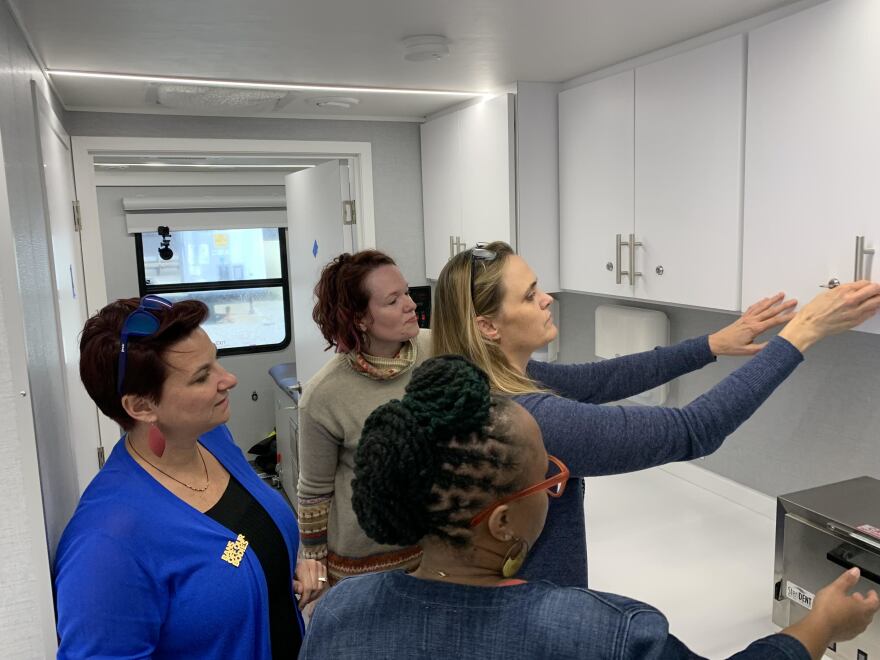 Planned Parenthood, including Dr. Colleen McNicholas, left, and LaQuetta Cooper, right, staff tour the new mobile clinic that will soon provide abortion pills to patients in Illinois.