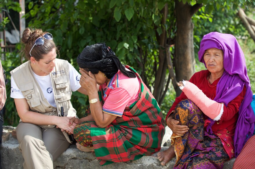 Kelly Suter (left), a nurse with International Medical Corps, counsels a survivor of the earthquake that devastated Nepal last April.