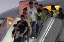 Migrants deported months ago by the United States to El Salvador under the Trump administration's immigration crackdown arrive at Simon Bolívar International Airport in Maiquetia, Venezuela, Friday, July 18, 2025. (AP Photo/Ariana Cubillos)