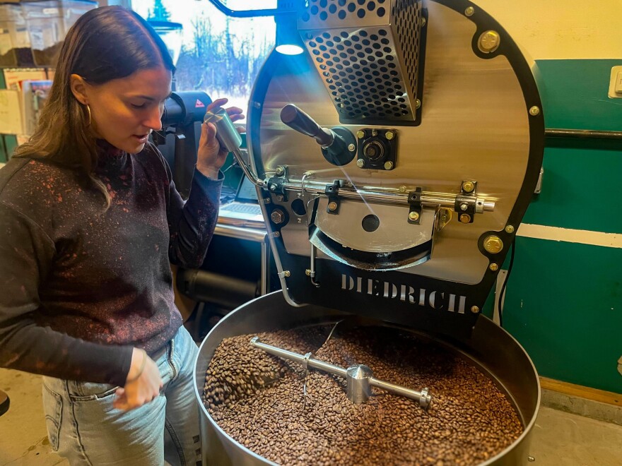 A girl watching coffee beans cool off
