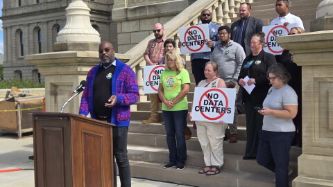 Kendell Joseph stands at the Michigan Capitol with a group opposing data centers.