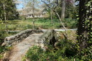 A stone bridge and wooded area in Fisher Park. 