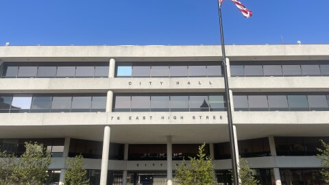 An American flag flies in front of Springfield City Hall.