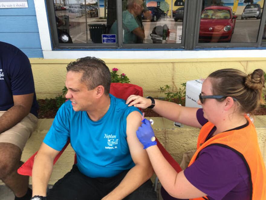 A nurse with the health department in Pinellas County delivered a hepatitis A shot to a restaurant employee in Gulfport this summer, part of the county's efforts to combat the virus. JULIO OCHOA/WUSF PUBLIC MEDIA