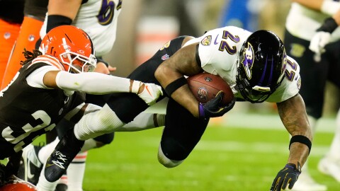 Baltimore Ravens running back Derrick Henry (22) is stopped by Cleveland Browns safety Ronnie Hickman (33) in the first half of an NFL football game in Cleveland, Sunday, Nov. 16, 2025. (AP Photo/Sue Ogrocki)