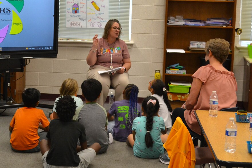 Students gather around their teacher for multi-sensory literacy instruction during Winston-Salem/Forsyth County Schools summer learning program. AMY DIAZ/WFDD