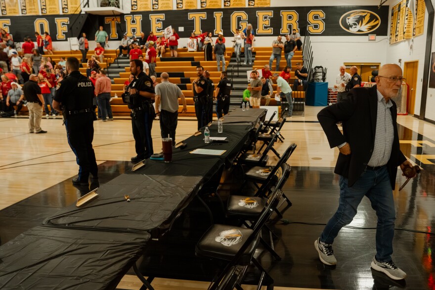 Festus Mayor Sam Richards, right, quickly exits a city council meeting after passing a plan to help develop a $6 billion data center in the community on Monday.