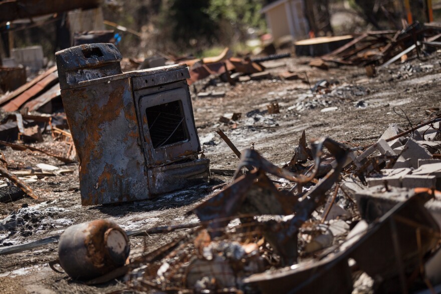 Debris from a burned home in Paradise waits to be cleared six months after the Camp Fire.