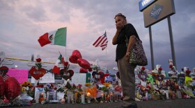 Catalina Saenz wipes tears from her face as she visits a makeshift memorial near the scene of a mass shooting at a shopping complex in El Paso, Texas. A list of the people who died in the weekend shooting rampage at the Walmart, shows that most of the victims had Latino surnames and included one German national.