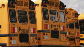 School buses are lined up in a storage lot, Thursday, Aug. 14, 2025, in Manchester, New Hampshire. (Charles Krupa/AP)
