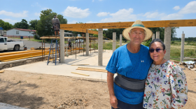 Scott and Juliet Welden in front of the construction of their new home in Kerrville