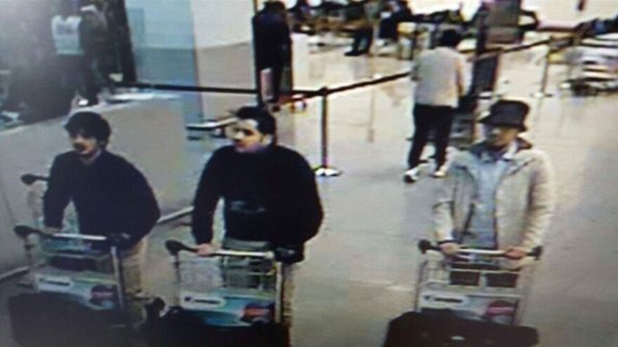 This image, provided by the Belgian Federal Police in Brussels, shows Ibrahim el Bakraoui (center), an unidentified attacker (left) and a wanted suspect (right) whose whereabouts are currently unknown.