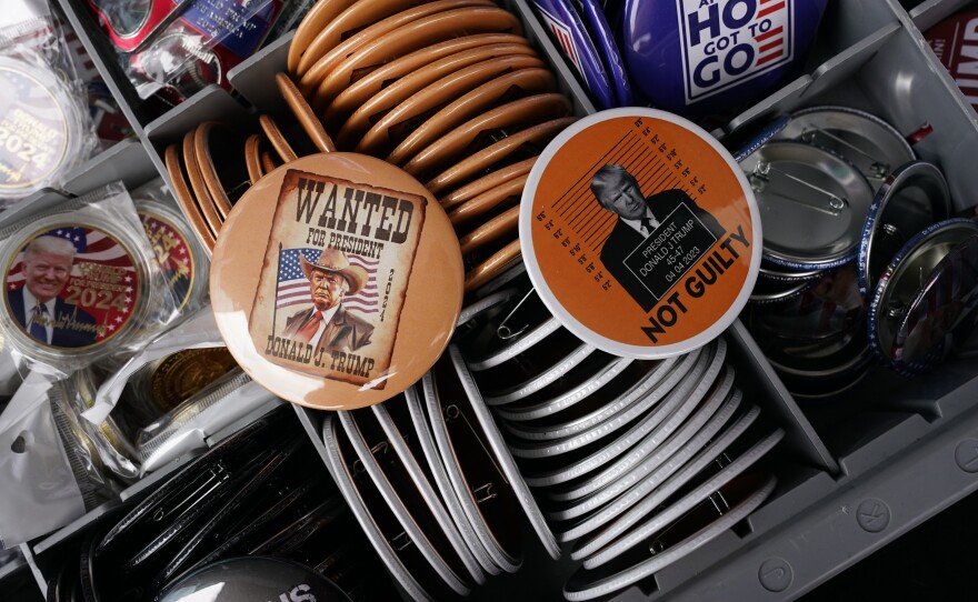 Pro-Trump buttons with messages such as "Wanted for President" and "Not Guilty" are seen on sale outside of the Fiserv Forum Tuesday, on the second day of the 2024 Republican National Convention in Milwaukee. The party's messages in the second session are expected to focus on safety.