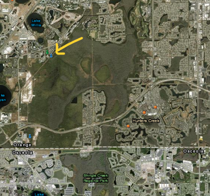 The Tuscana proposal seeks to build the planned development in the Shingle Creek wetlands area, just east of International Drive and north of State Road 417. A blue pin and yellow arrow mark the proposed site location in the screengrab above.