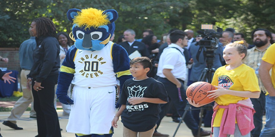 Children from the Shepherd Community Center in Indianapolis play basketball with Indiana Pacers mascot Boomer.