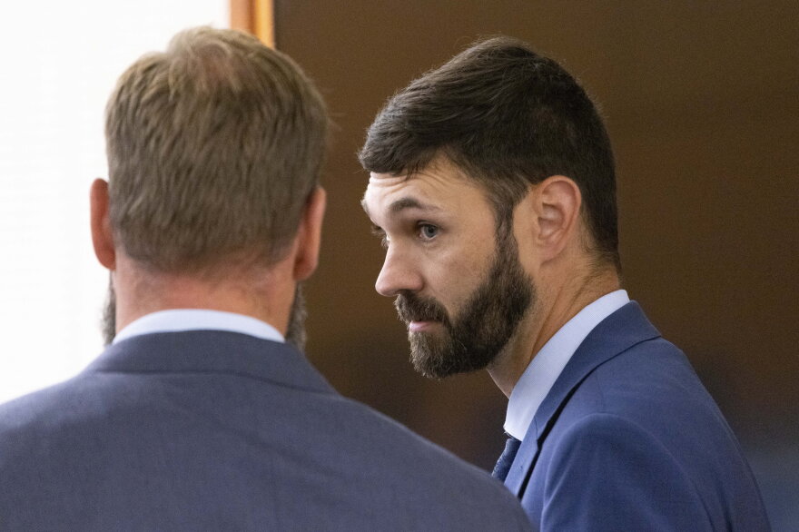 Tacoma Police officers Matthew Collins, left, and Christopher "Shane" Burbank chat shortly before the beginning of their trial for the death of Manny Ellis in Pierce County Superior Court in Tacoma Wednesday, October 4, 2023.