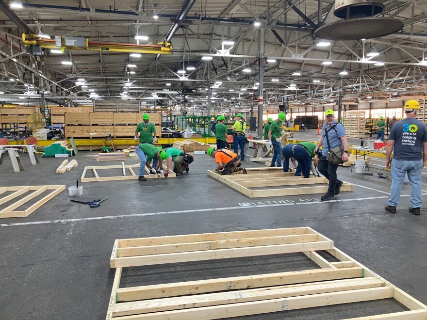 John Deere Harvester Works employees volunteer to build wood frames for a Habitat for Humanity home at the East Moline plant, Friday, May 29, 2026.