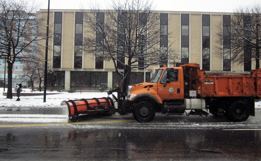 A plow makes its way down Elm street in Manchester