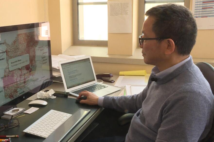 Indiana University Professor Chen Zhu shows how people can use the mapping tool to find out how much water might be lost in their community in the future.