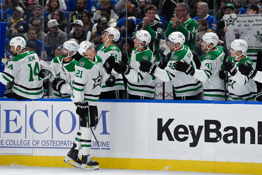 Dallas Stars left wing Jason Robertson (21) celebrates with teamamtes after scoring during the first period of an NHL hockey game against the Buffalo Sabres, Thursday, Oct. 8, 2026, in Buffalo, N.Y. (AP Photo/Adrian Kraus)