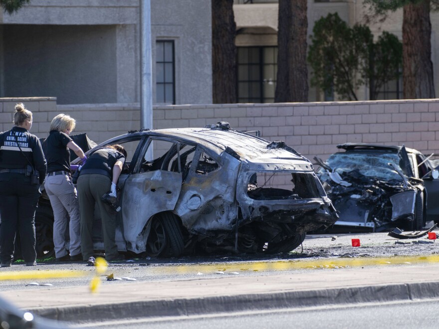 Las Vegas Metro Police investigators work at the scene of a fatal crash Tuesday. Police say Las Vegas Raiders wide receiver Henry Ruggs III was involved in the fiery vehicle crash that left a woman dead and Ruggs and his female passenger injured.