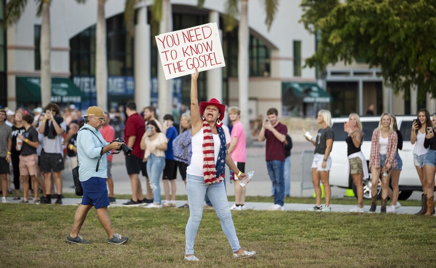 A supporter of Florida Governor Ron DeSantis yells at FGCU students on Sunday outside DeSantis' campaign rally at Alico Arena in Fort Myers. More than 30 FGCU students marched from the campus' Veterans Pavilion to Alico Arena in protest of DeSantis speaking at the rally. The protest was organized by the Young Democratic Socialists of America at FGCU, who oppose DeSantis' policies on education, LGBTQ and abortion.