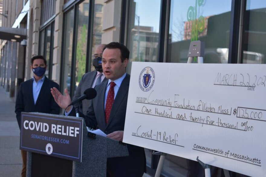 a press conference with a big cardboard check