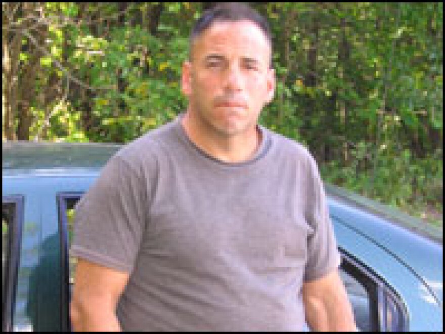 Joe Raicaldo leans against the '98 Plymouth he has been living in since his honorable discharge from the Army after he was injured in Iraq.