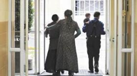Amy Jessup (center) of Allen County leaves the Allen County Courthouse in Scottsville on Wednesday with friends Keely and Daniel Showalter and their son Philo, 1, all of Barren County, after Jessup's Allen District Court proceedings concerning home-school