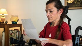 Lori Taylor reads the second letter she received from the state Department of Human Services informing her that her Medicaid waiver program will be funded temporarily. 