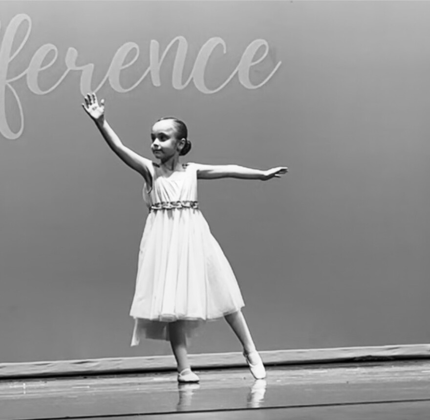 7-year-old Gigi Riley dancing on stage independently in her fourth year of classes