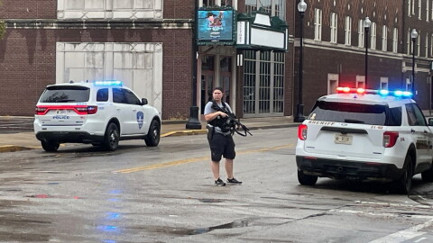 An unidentified officer is armed with an automatic weapon outside Signature School after an apparent false report of someone with a gun inside the downtown school