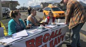 Recall Dunleavy volunteers Frankie Urquhart, left, Jessie Chapman and Pat Chapman gather signatures on Aug. 1 in downtown Ketchikan for a petition to remove Gov. Mike Dunleavy from office. (Photo by Elizabeth Gabriel/KRBD)