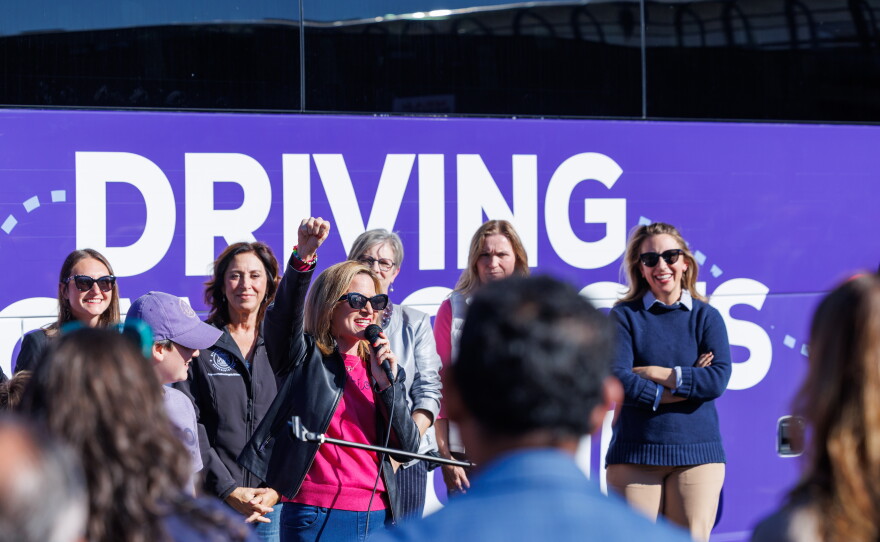 Democratic gubernatorial nominee Jocelyn Benson speaks in East Lansing, Mich., on Oct. 22, 2026, during the first stop on her statewide "Driving Down Costs" bus tour.