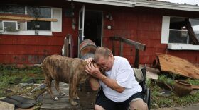 Steve Culver cries with his dog Otis as he talks about what he said was the, "most terrifying event in his life," when Hurricane Harvey blew in and destroyed most of his home while he and his wife took shelter there on August 26, 2017 in Rockport, Texas. Photo by Joe Raedle/Getty Images