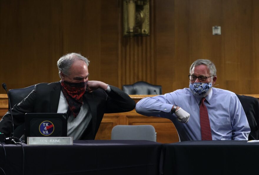 US Senators Tim Kaine (D-VA) and Richard Burr (R-NC) greet each other with an elbow bump before the Senate Committee for Health, Education, Labor, and Pensions hearing to examine COVID-19 and Safely Getting Back to Work and Back to School in Washington, DC.