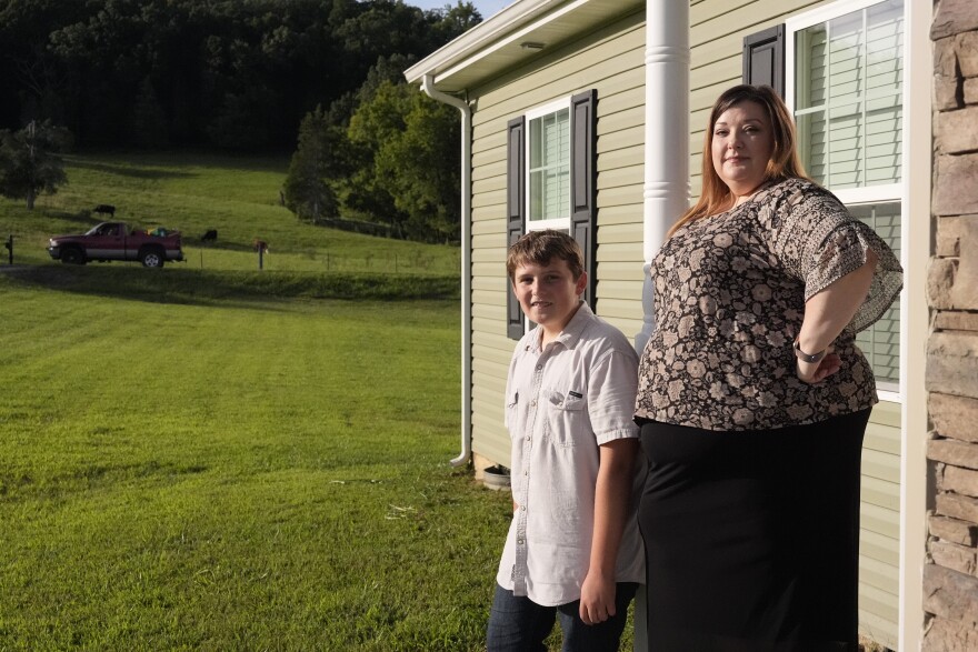Heather Colley, right, poses with her son, Michah, outside their home Wednesday, Aug. 27, 2025, in Talbott, Tenn. (AP Photo/George Walker IV)