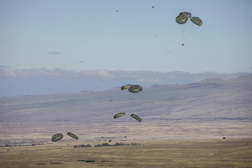 FILE - In this photo released by the U.S. Army, U.S. Air Force conducts an airdrop during Joint Pacific Multinational Readiness Center (JPMRC) at Pōhakuloa Training Area, Hawaiʻi, Nov. 4, 2023.