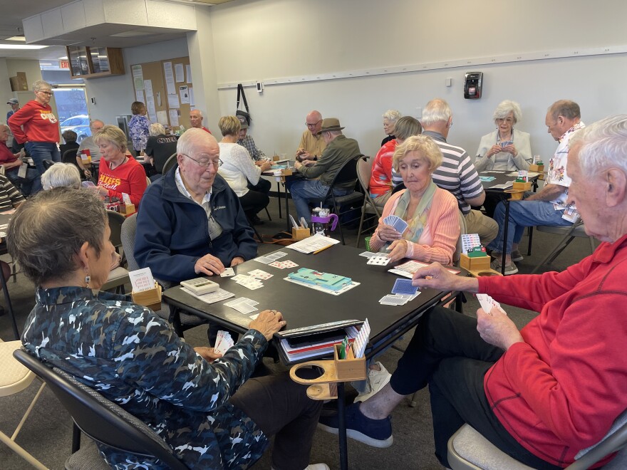Don Stack (left) and Donald Brooker (right) compete against Tori Billard (left) and Jeanie Brown (right) at the Kansas City Bridge Studio in Overland Park, Kansas.