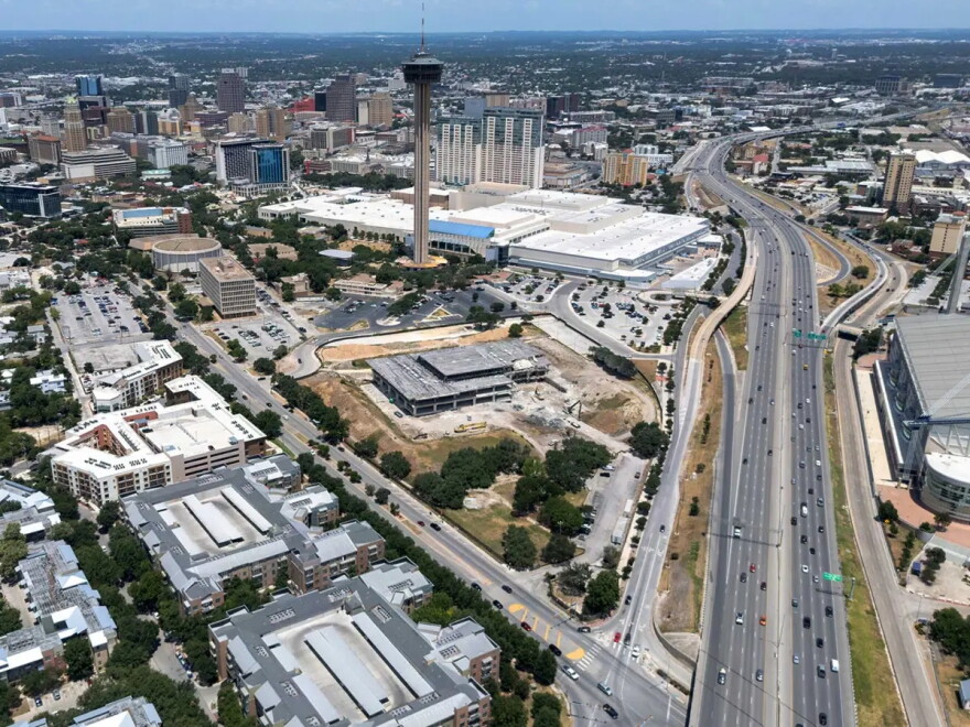 An aerial image shows downtown San Antonio, the Hemisfair area, I-37 and parts of the Alamodome and East Side. The Institute of Texan Cultures, shown in the foreground, was undergoing demolition when this image was taken in 2025.
