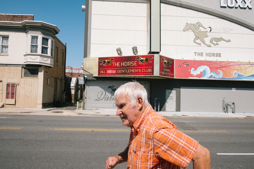 A man walks by The Horse Gentlemen's Club on the south end of the Atlantic City boardwalk.