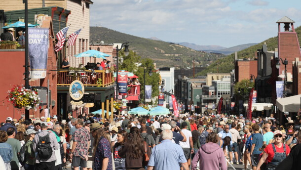 Crowds walk down Park City Main Street after the 2026 Miners Day Parade.