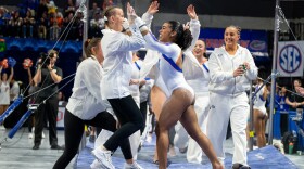 Florida gymnast eMjae Frazier celebrates with her teammates after her bar routine during an NCAA gymnastics meet against Alabama in Gainesville, Fla., Friday, Jan. 16, 2026. (Bayden Armstrong/WRUF)