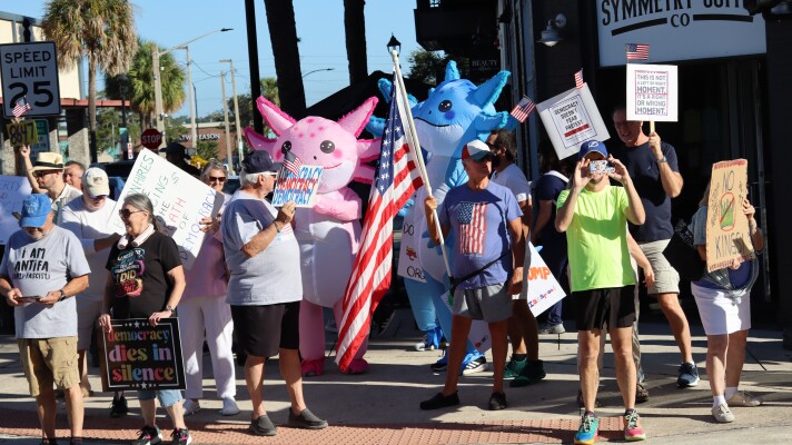 Hundreds of protesters, some wearing inflatables, rallied against the Trump administration and its policies in Ocala on Saturday.