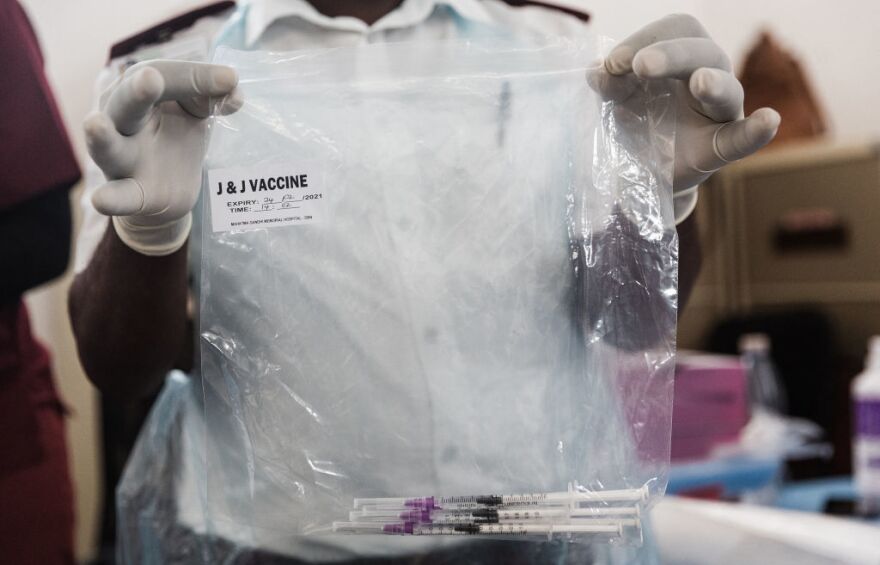 A health care worker holds doses containing J & J vaccines to be administered is seen ahead of the launch of the VaxuMzansi National Vaccine Day Campaign at the Gandhi Phoenix Settlement in Bhambayi township, north of Durban , on September 24, 2021. - The campaign launched by the Religious Forum Against Covid-19 (RFA) is an inter-faith collaboration of various religious communities standing together to fight the spread of the pandemic. The campaign aims to encourage congregations and followers to vaccinate with a sense of urgency to increase vaccine uptake. (Photo by Rajesh JANTILAL / AFP) (Photo by RAJESH JANTILAL/AFP via Getty Images)