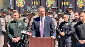Acting ICE Director Todd Lyons, center, is flanked by Orange County Sheriff John Mina, left, and Florida Highway Patrol Executive Director Dave Kerner, right, at a Friday afternoon press conference at the FHP Orlando office on International Drive.